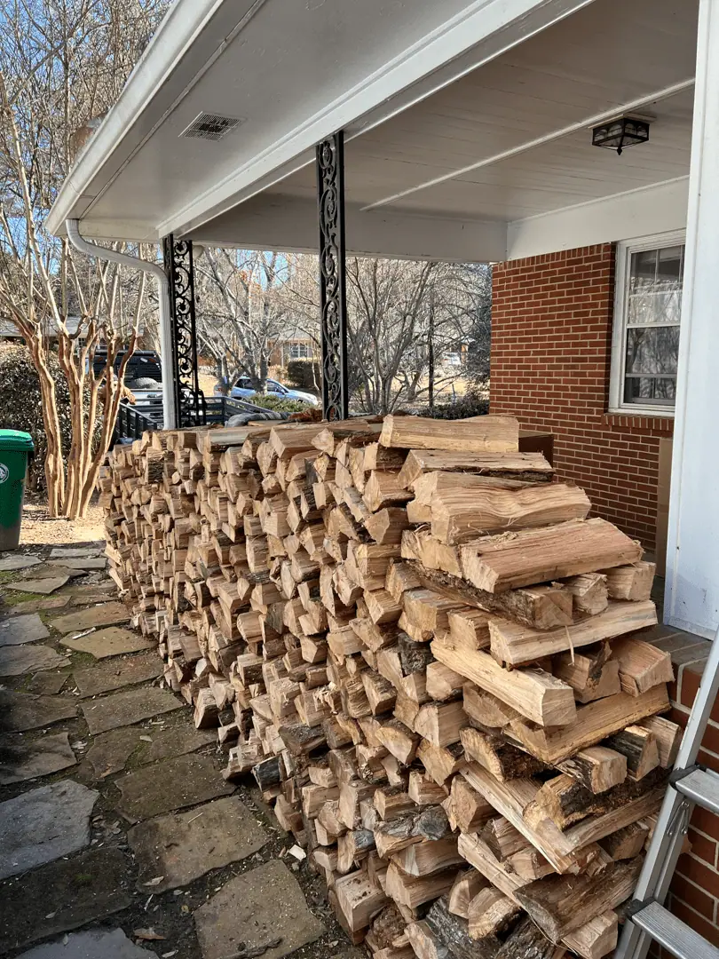 Firewood stacked high along a covered porch